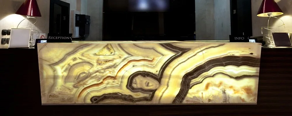 Kamenný barový pult z leštěné černé žuly v moderním baru