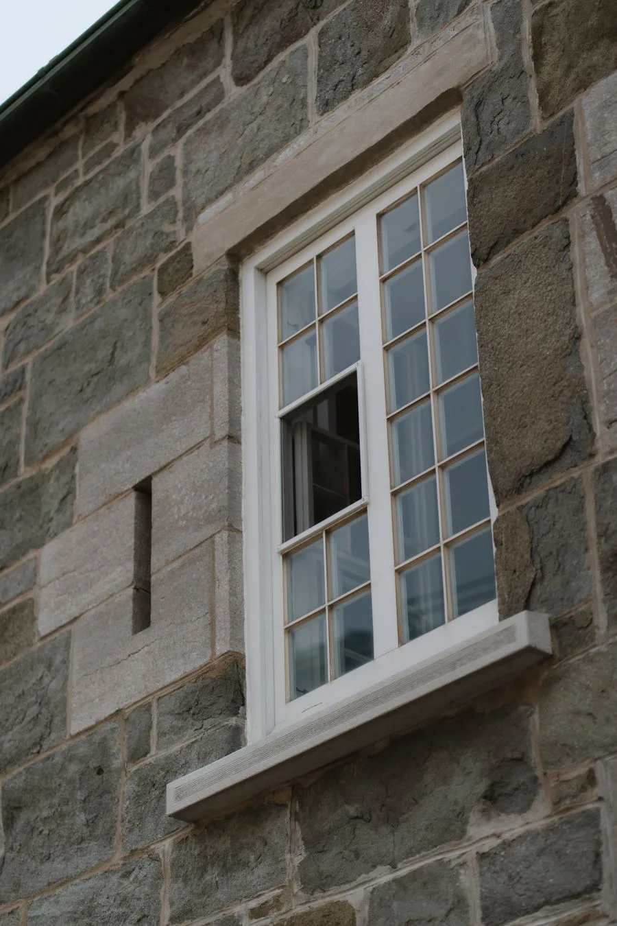 Tmavý granitový venkovní parapet na moderní fasádě